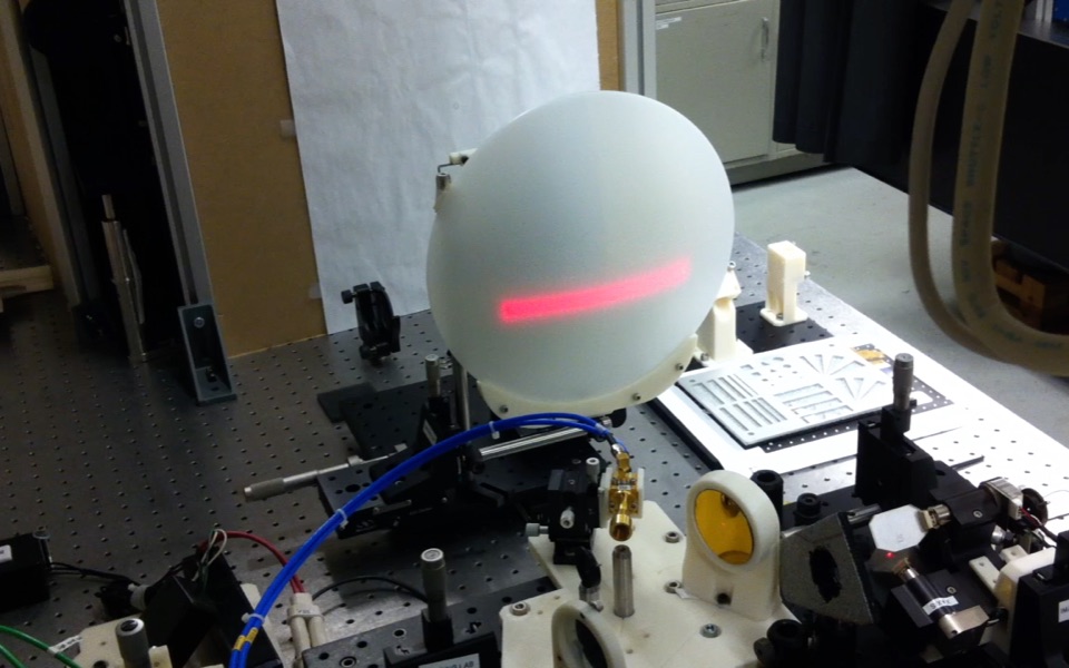 Terahertz scanner prototype projecting a red scan line onto a test target
